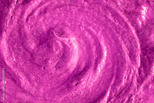 Smears of liquid purple magenta gel texture background. Smeared oil paint with pearly shine. Cream scrub to cleanse the skin of the face and body. Spa treatments, skin care.