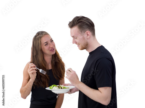 couple eating salad in the kitchen