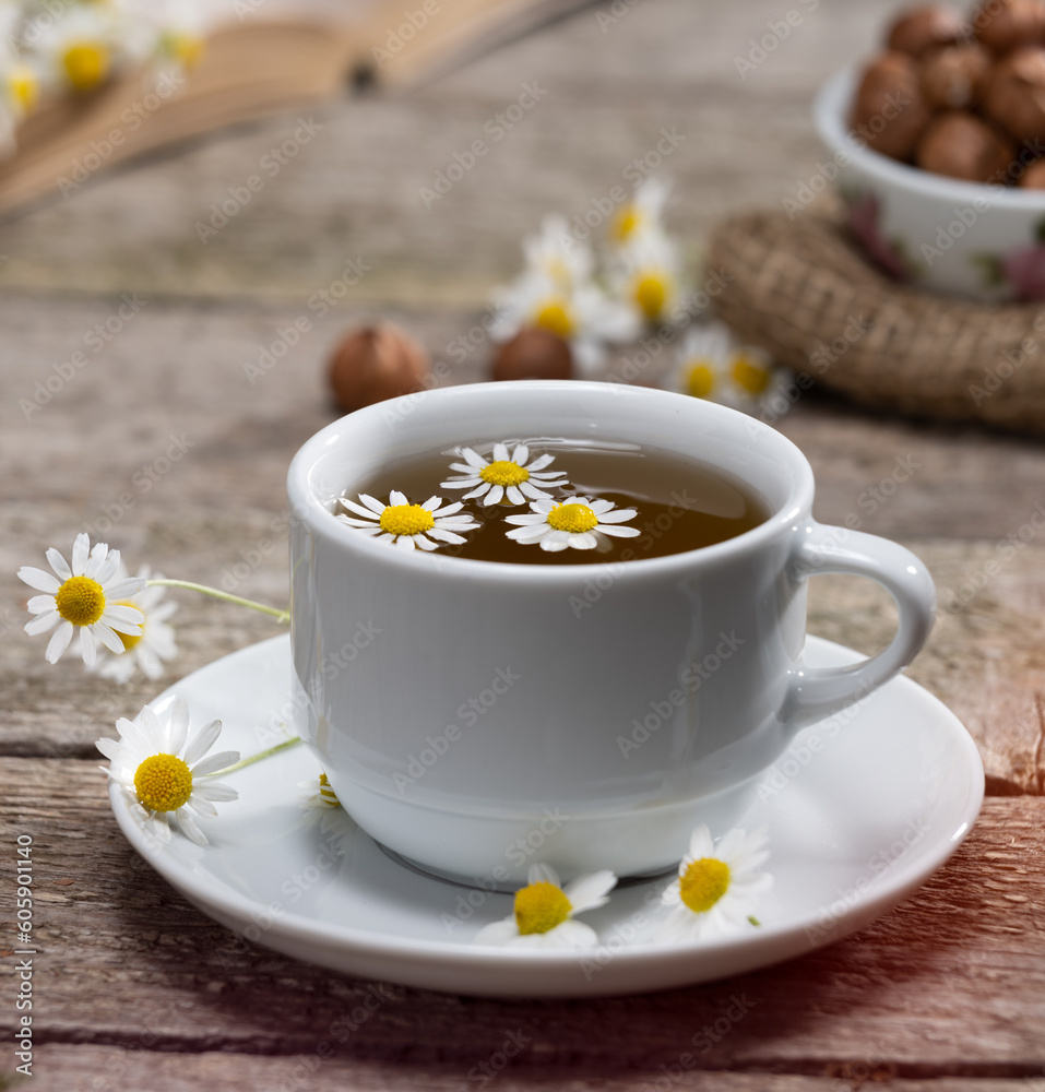 Herbal teas. Cup of fresh chamomile tea on wooden table Herbal teas. Cup of fresh chamomile tea on wooden table