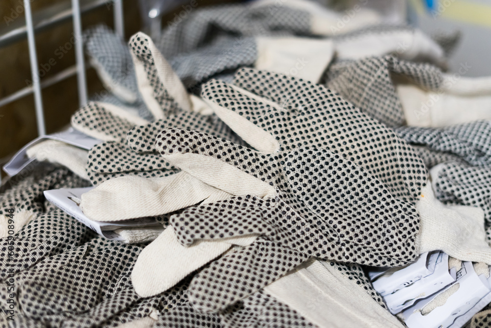 Rubberized grey work gloves hanging on the wall. Part of work-wear and protection equipment. Rubberized grey work gloves hanging on the wall. Part of work-wear and protection equipment.