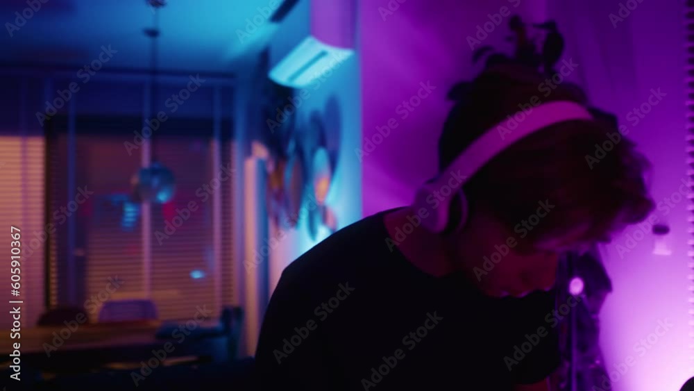 Young caucasian man dancing at home among neon lights. Shot with RED helium camera in 8K Young caucasian man dancing at home among neon lights. Shot with RED helium camera in 8K
