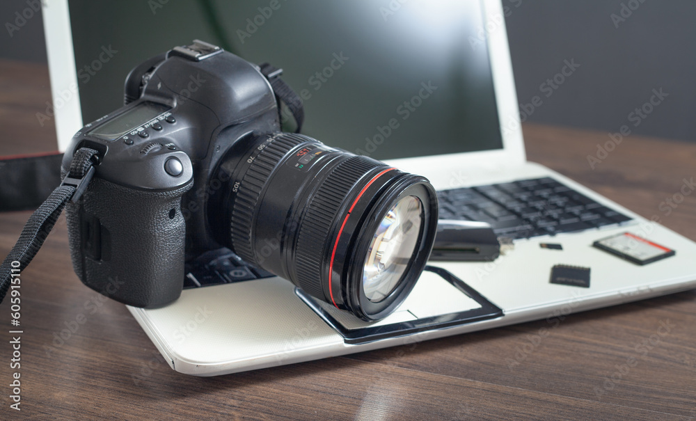 Modern DSLR camera and laptop computer.