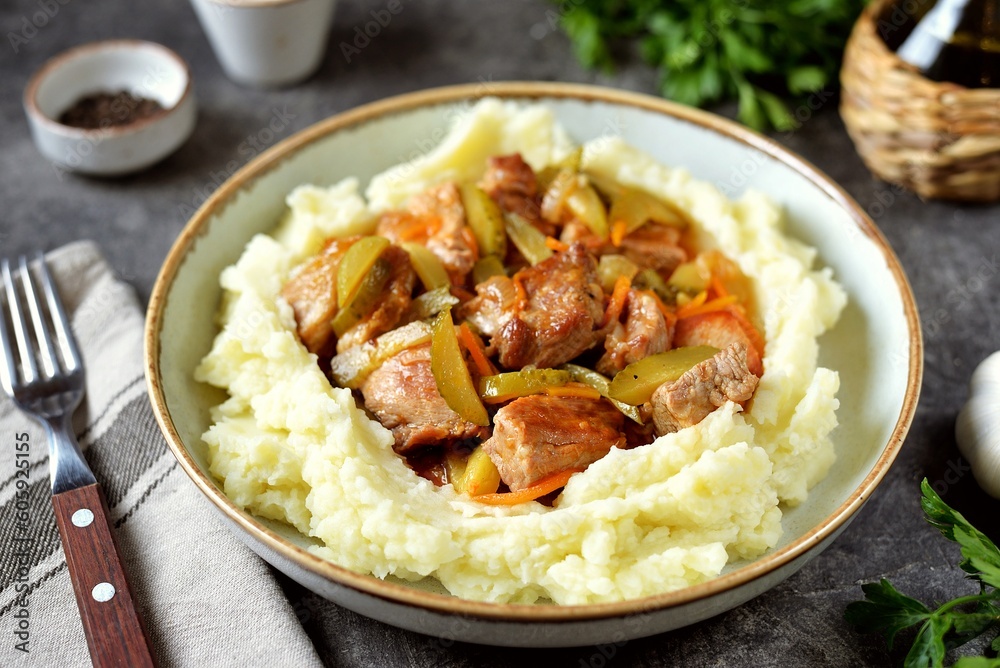 Braised pork with pickled cucumbers and mashed potatoes. Braised pork with pickled cucumbers and mashed potatoes.