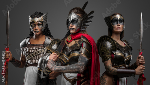 Shot of isolated on grey background female warriors from past with spears and sword.