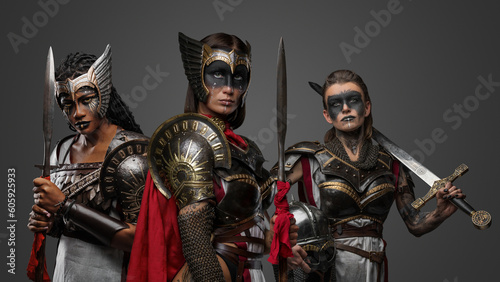 Portrait of multiracial group of female warriors from past against grey background.