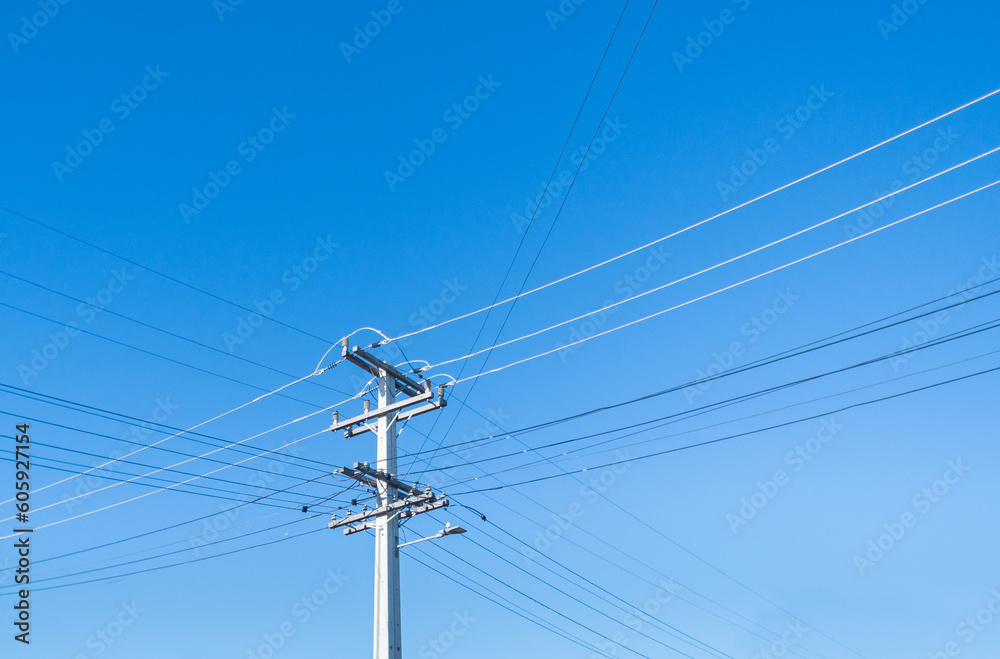 Power post and powerlines against a cloudless blue sky. Auckland. Power post and powerlines against a cloudless blue sky. Auckland.