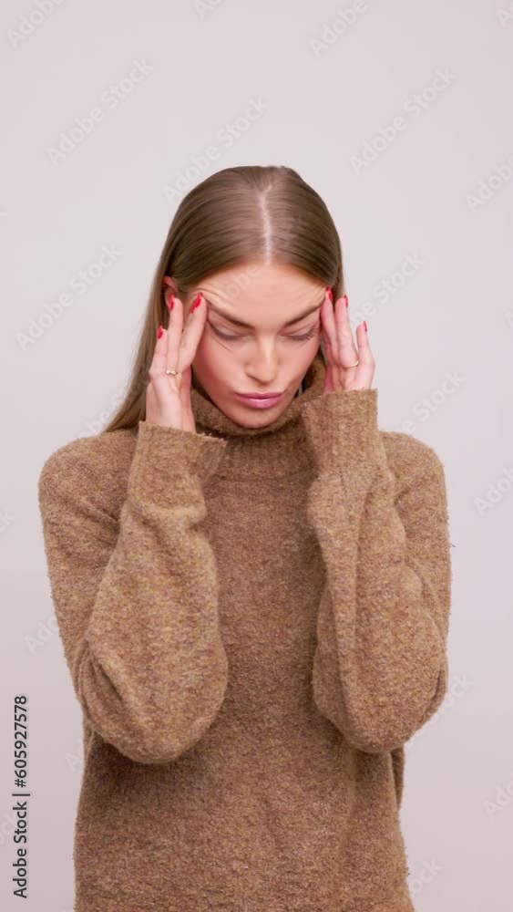 Young female girl woman with headache shaking her head and being in pain Young female girl woman with headache shaking her head and being in pain
