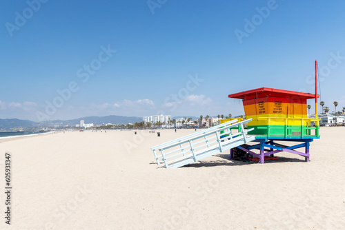A vibrant photo of a lifeguard tower in the colors of the pride flag