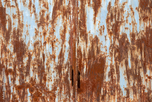 close-up view of an old rusted metal door