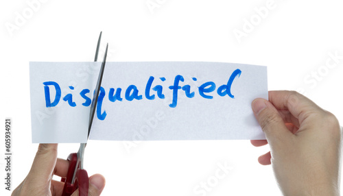 Scissors cutting word unqualified on paper
