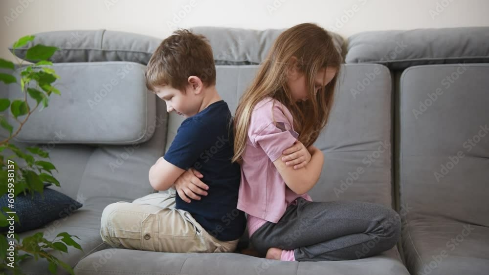 offended brothers and sisters sit back to back on the couch. children's emotions