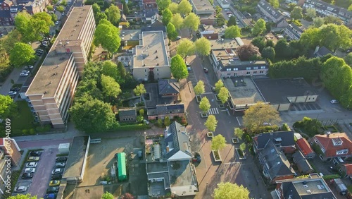 Drone pulling back from main street and revealing a beautiful small town at golden hour photo