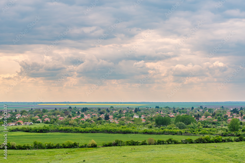 Fototapeta premium Beautiful rural landscape in Northern Bulgaria, village and agriculture field in springtime.