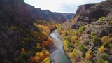 Witness the mesmerizing drone footage that unveils a river canyon transformed into a symphony of fall colors. Generated by AI.