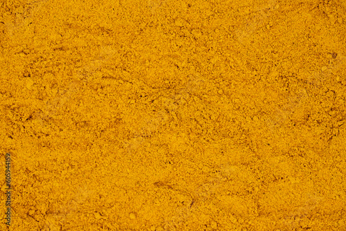 Pile of turmeric powder as background, spice or seasoning as background. Ground or sifted turmeric. Indian spice. Top view