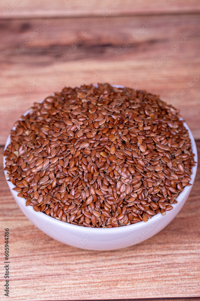 Linseed on wooden background. Flax seed or Flax seed in ceramic bowl. Close up Linseed on wooden background. Flax seed or Flax seed in ceramic bowl. Close up