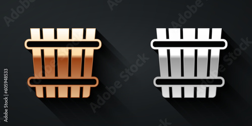 Gold and silver Sauna bucket icon isolated on black background. Long shadow style. Vector