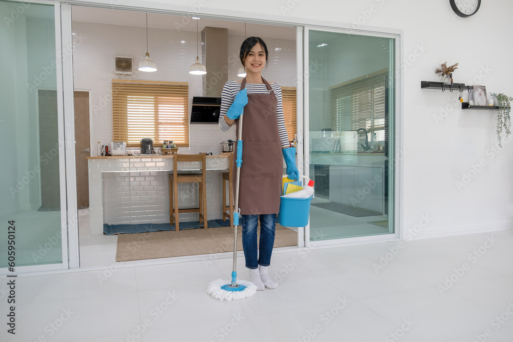 Woman, housewife holding mop and bucket of cleaning materials.