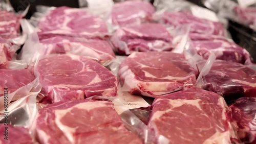 Many steaks packaged and vacuum packed in plastic bags ready for sale