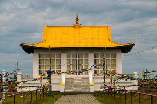 Obraz na płótnie A building for the Dalai Lama surrounded by prayer flags near Syakyusn-Syume (Old hurul)