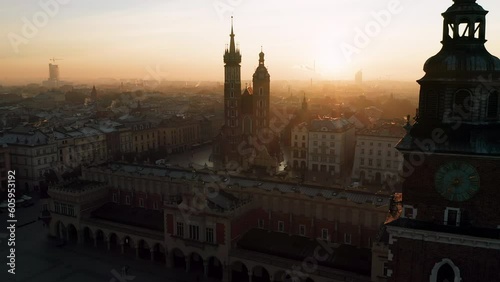 Panorama of Old Town (Main Square, Saint Mary's Basilica, Sukiennice - Town Hall, Town Hall Tower) in Krakow (Cracow), Poland during magic sunrise with soft morning light. photo