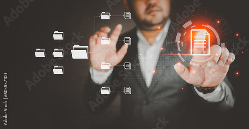 Businessman in suit hand using virtual screen showing innovation Document Management System DMS. Transfer file of data between folder, Backup data, Exchange of file on folder, DMS. Virtual document. © Dontree