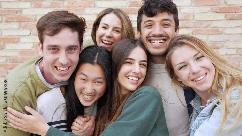 Multiracial group of people smiling at camera outside Multiracial group of people smiling at camera outside