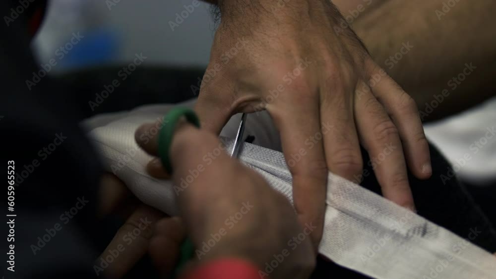 Boxing Hand Wrapping by Coach before a Fight, cutting the wrap close up Boxing Hand Wrapping by Coach before a Fight, cutting the wrap close up