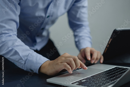 Businessperson using keyboard laptop computer job search, communication social networking, internet online Information, working data marketing concept.