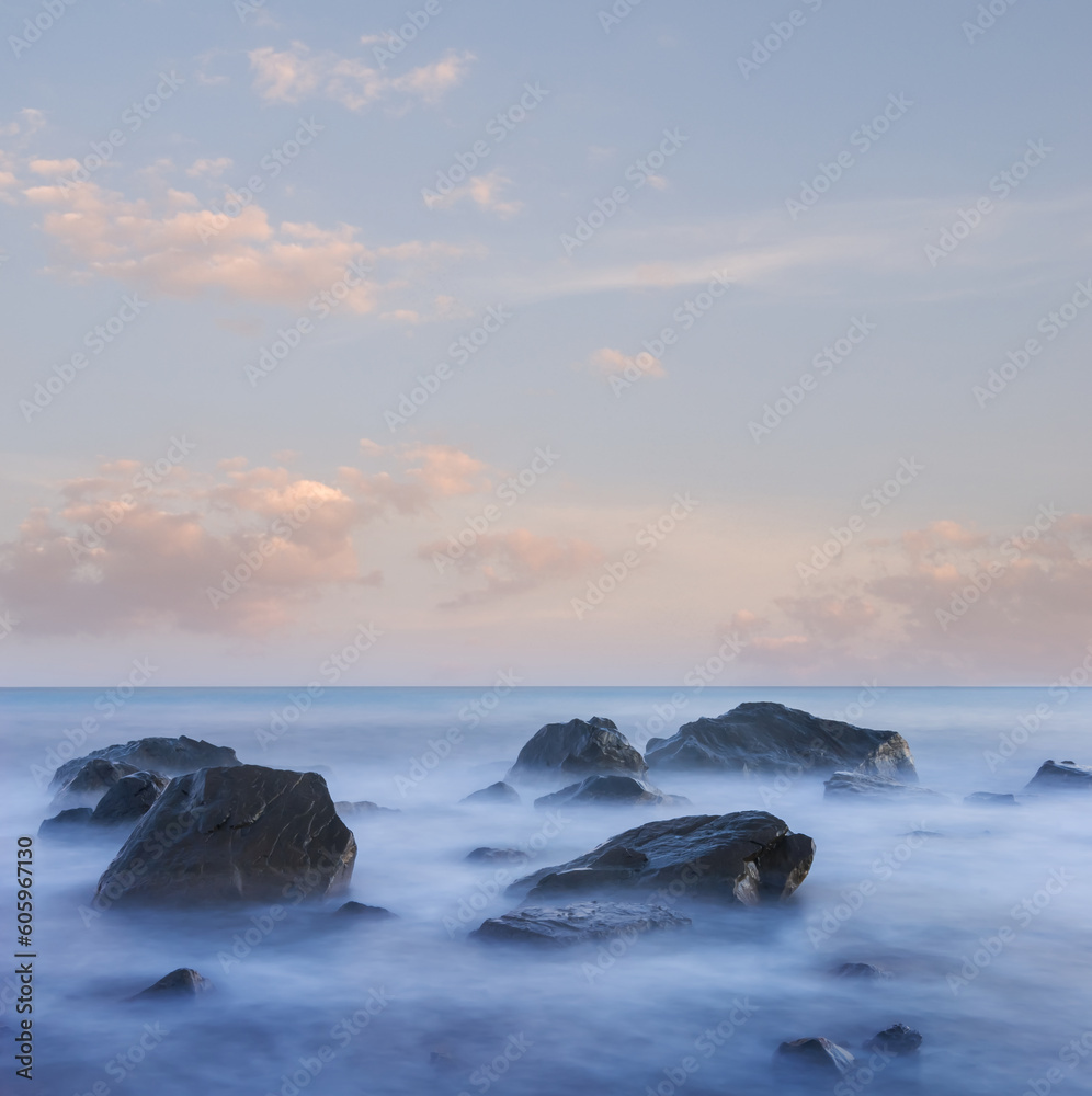 sea coast with stones at the early morning, long exposure sea landscape