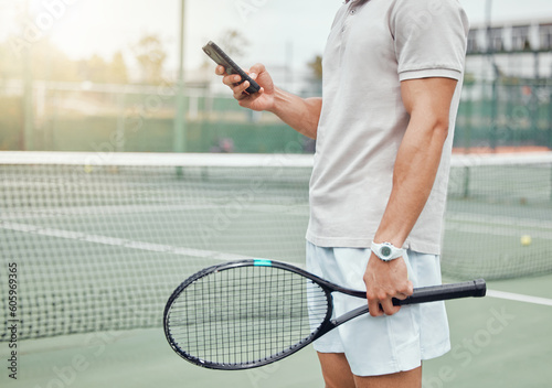 Man, hands and phone on tennis court for social media, communication or chatting in sports for match or game. Hand of male person or player holding racket texting on mobile smartphone for online chat © Clement C/peopleimages.com
