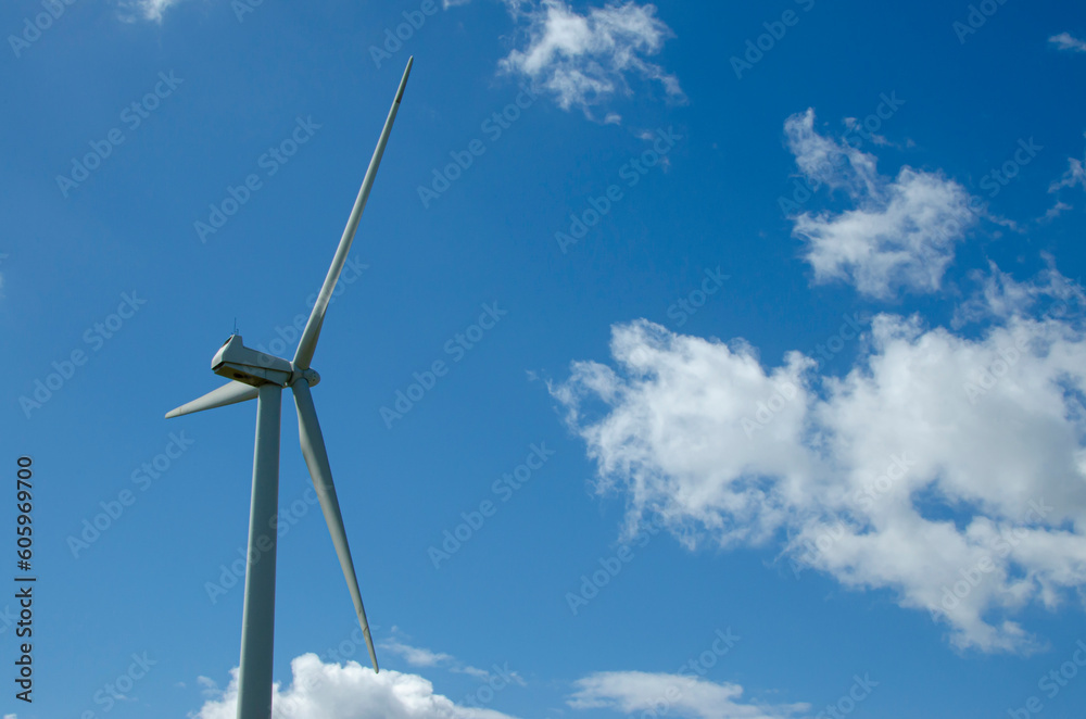 Windmill generating power on a cloudy day Windmill generating power on a cloudy day