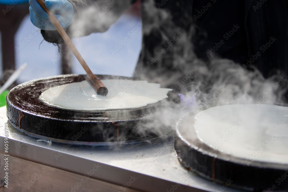 Fototapeta premium Pour the pancake batter into the skillet. Prepare pancakes.