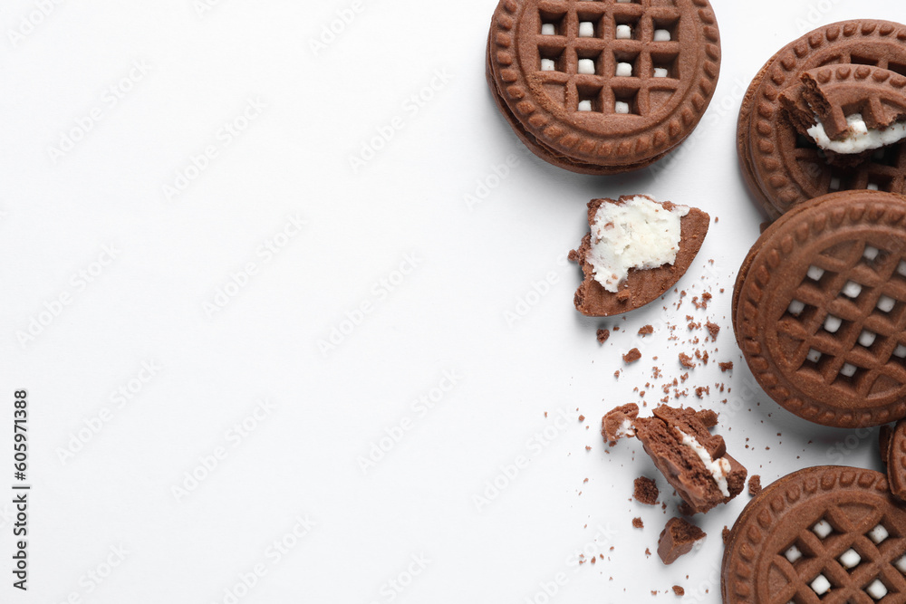 Tasty sandwich cookies with cream on white background, flat lay. Space for text Tasty sandwich cookies with cream on white background, flat lay. Space for text
