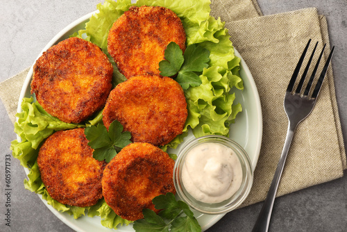 Tableau sur toile Tasty vegan cutlets served with sauce on light grey table, top view