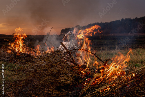 young guy crying in fire in burnt clothes  war  home destruction  human disappointment