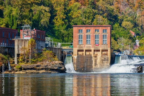 the dam is in the water by the bank of the river photo