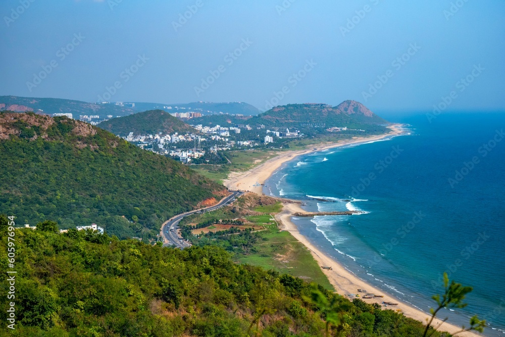 Mesmerizing view of the green mountains on the coast with city and roads