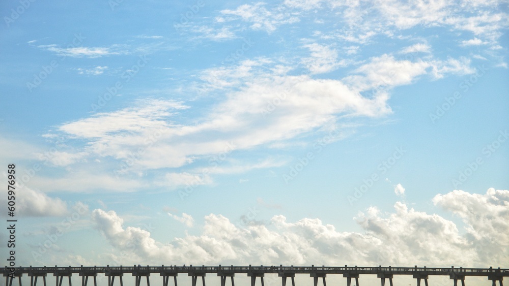 Obraz premium Bridge under the blue sky and white clouds