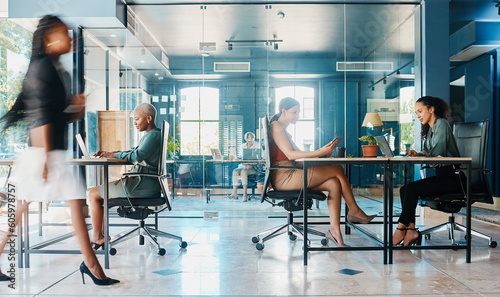 Busy, coworking and business people in the office for work with company diversity at an agency. Blur, corporate and employees in the workplace for professional commitment in an executive career