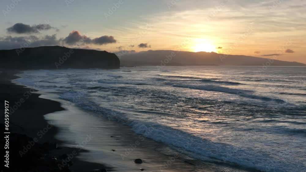 Vivid sunset over ocean, waves crashing on Santa Barbara beach, Azores. Aerial Vivid sunset over ocean, waves crashing on Santa Barbara beach, Azores. Aerial