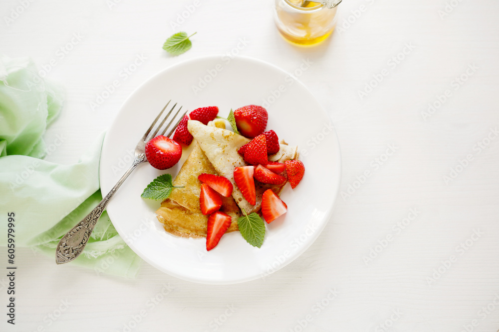 crepes with fresh strawberries on light surface crepes with fresh strawberries on light surface