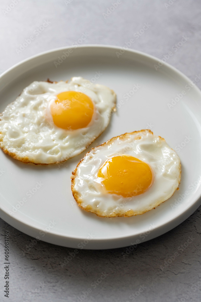 Fried eggs in a plate, food breakfast, healthy proteins. Fried eggs in a plate, food breakfast, healthy proteins.