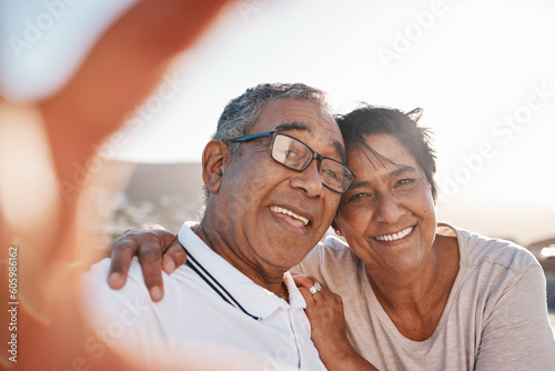 Selfie, romance and a senior couple on the beach together during summer for a retirement holiday or vacation. Portrait, smile or dating with an old husband and wife posing for a photograph by the sea