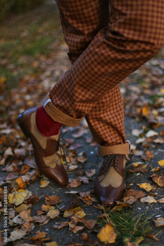 Man standing in an autumn park in beautiful shoes, vintage style 