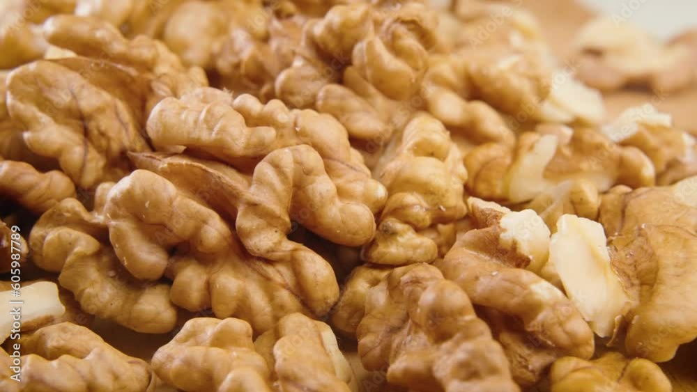 Close-up view of many walnuts on a wooden table Close-up view of many walnuts on a wooden table