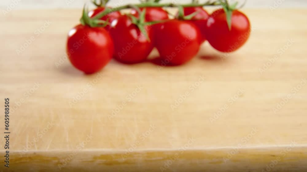 Close-up shot of red cherry tomatoes on a wooden board Close-up shot of red cherry tomatoes on a wooden board