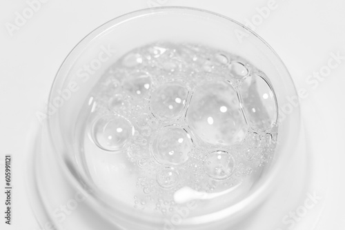 Transparent gel or liquid with bubbles in a round container