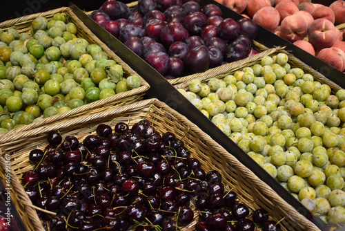 Fototapeta Naklejka Na Ścianę i Meble -  Fresh food market organic cherries, grapes and plums in baskets