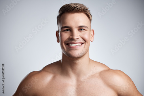 Portrait of happy man, fitness and muscle on studio, background and backdrop of strong power, athletic confidence and athlete. Face, muscular bodybuilder and topless male model smile for sports pride